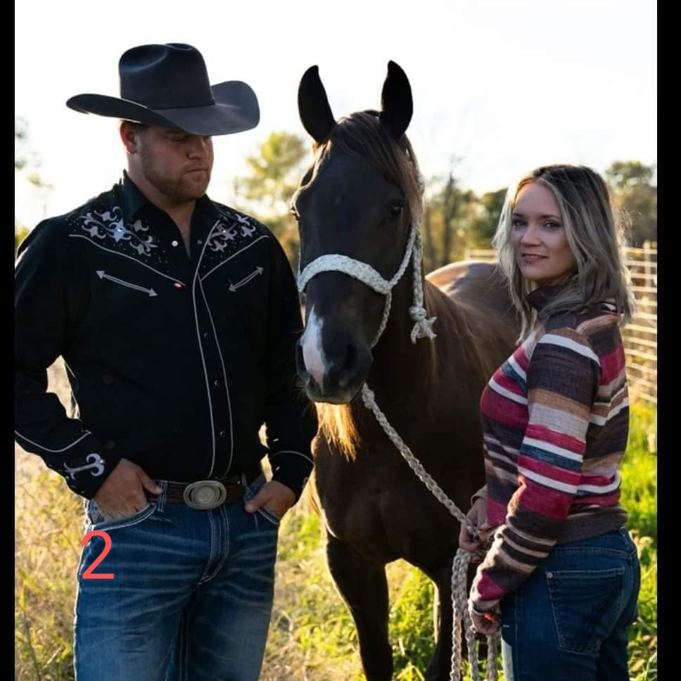 A couple standing beside a horse outdoors